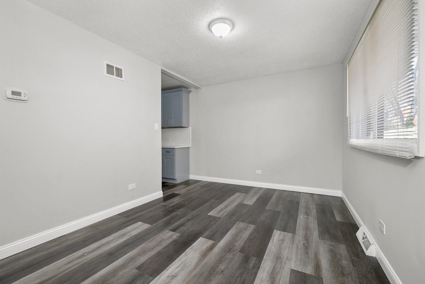 17522 Wright Street Lansing, IL 60438 - Photo 14 of 21 a view of empty room with wooden floor and fan