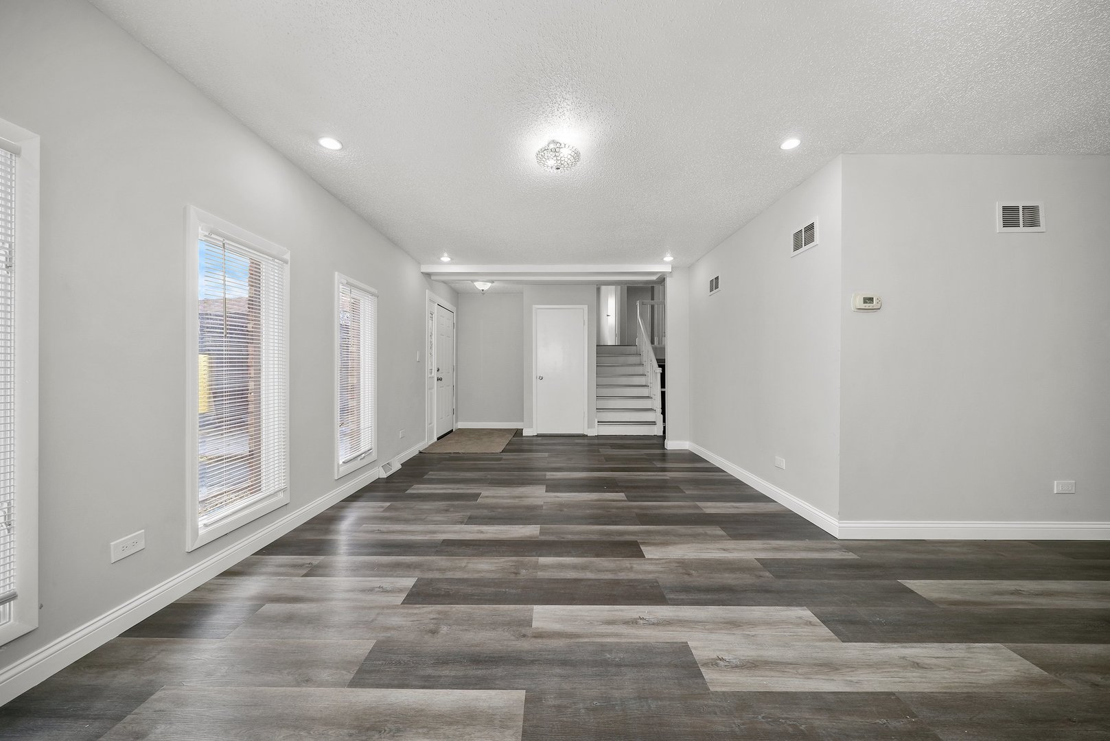 17522 Wright Street Lansing, IL 60438 - Photo 7 of 21 a view of empty room with wooden floor and fan