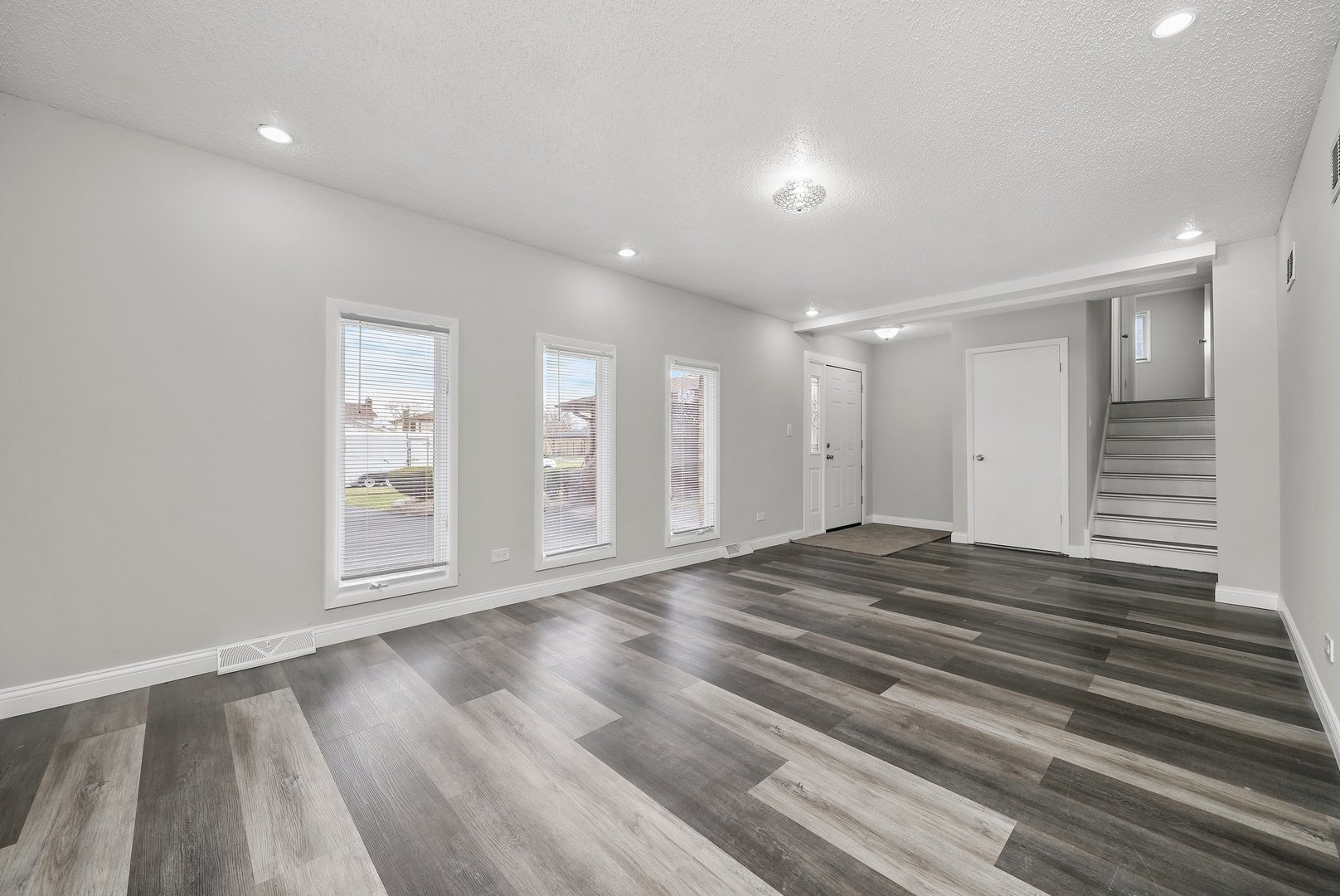 17522 Wright Street Lansing, IL 60438 - Photo 8 of 21 a view of empty room with wooden floor and fan