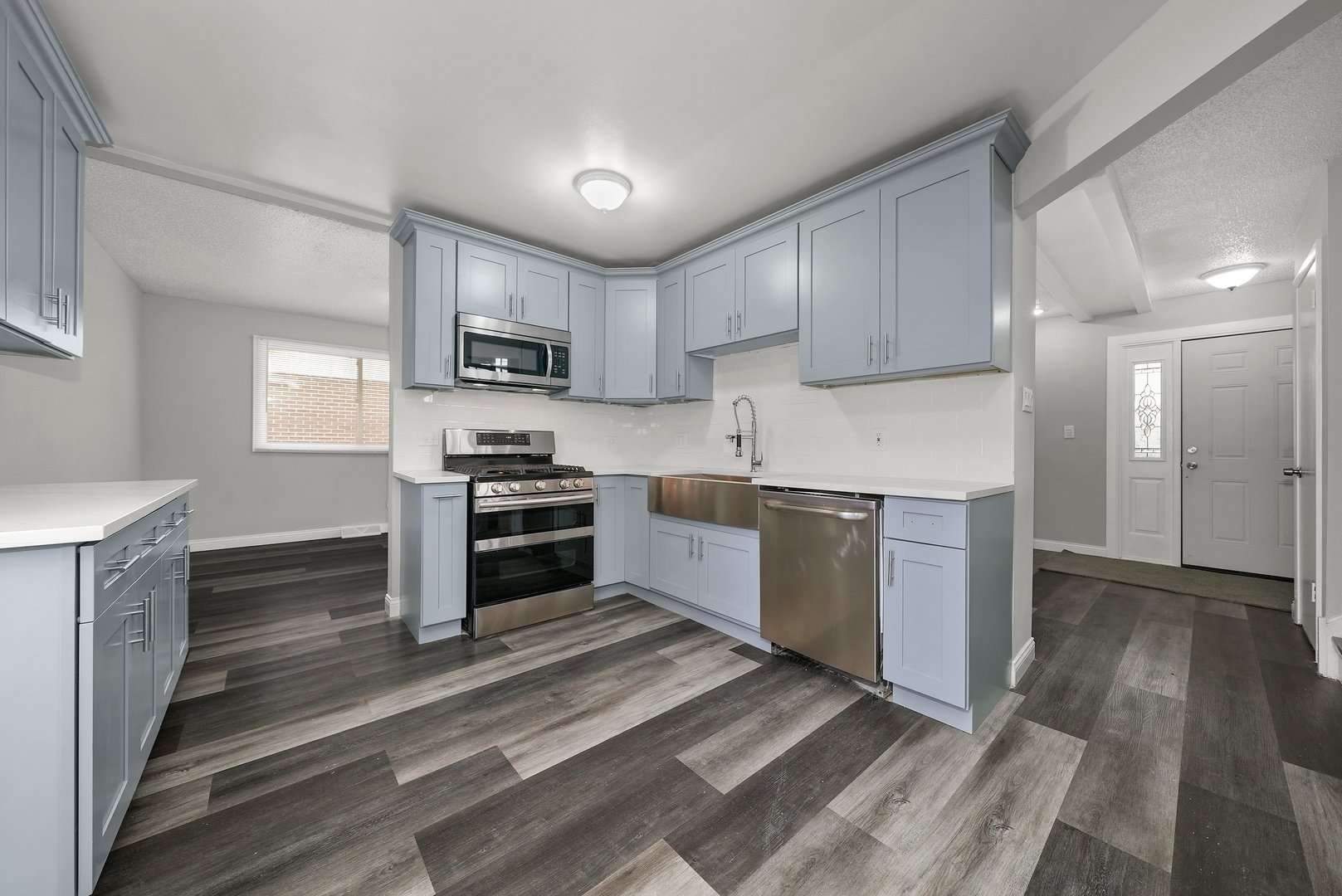 17522 Wright Street Lansing, IL 60438 - Photo 9 of 21 a kitchen with granite countertop a refrigerator and a stove top oven