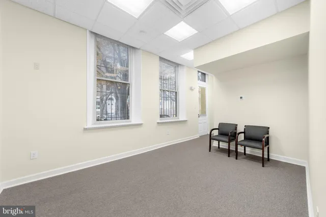 a view of a livingroom with furniture and a window