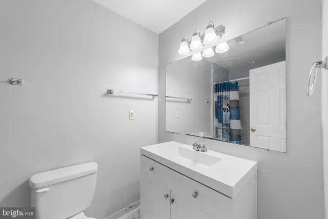 a bathroom with a sink vanity and a mirror