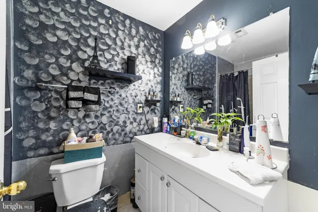 a bathroom with a sink mirror and vanity