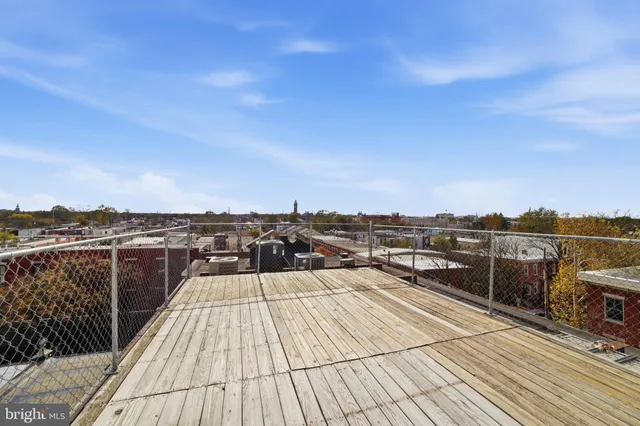 a view of a balcony with wooden floor