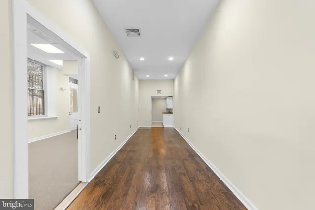 a view of hallway with wooden floor
