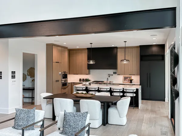 a large kitchen with a table and chairs in it
