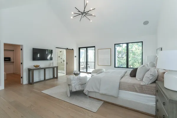 a bedroom with a bed and a flat screen tv