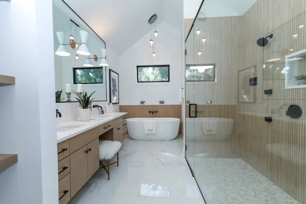 a spacious bathroom with a large tub shower and sink