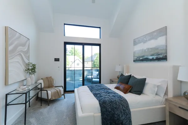 a bedroom with a bed and glass window