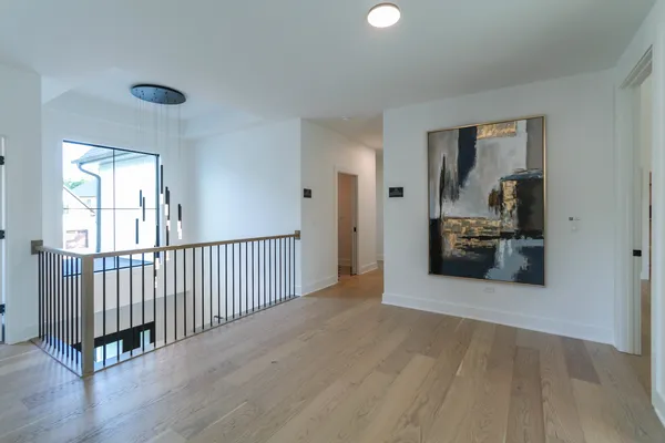 a view of a room with wooden floor and windows