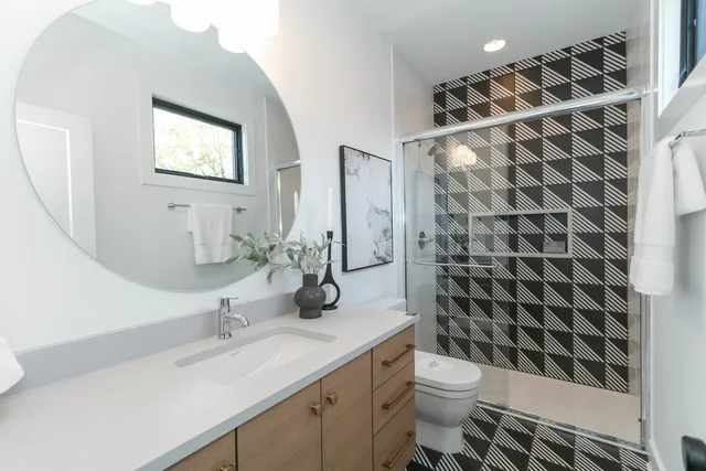 a bathroom with a sink toilet and shower