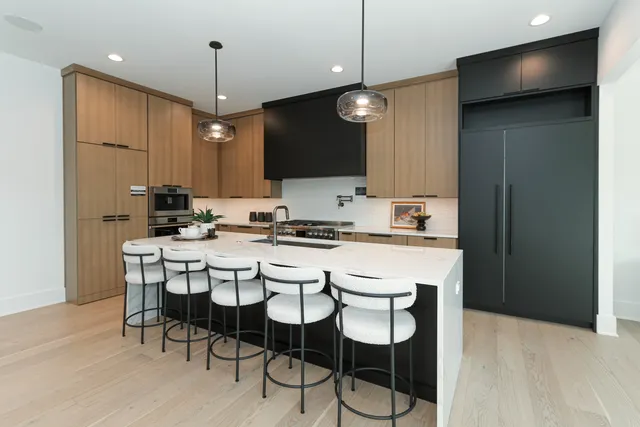 a kitchen with kitchen island granite countertop a sink a center island and cabinets