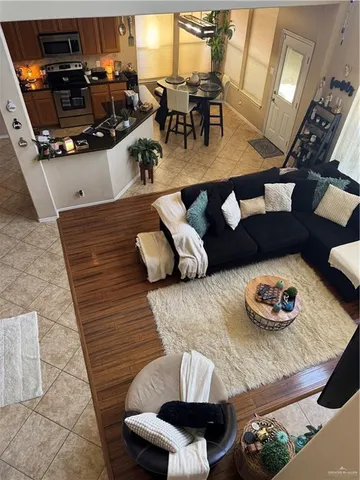 a living room with furniture and wooden floor