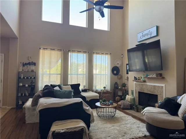 a living room with furniture a fireplace and a flat screen tv