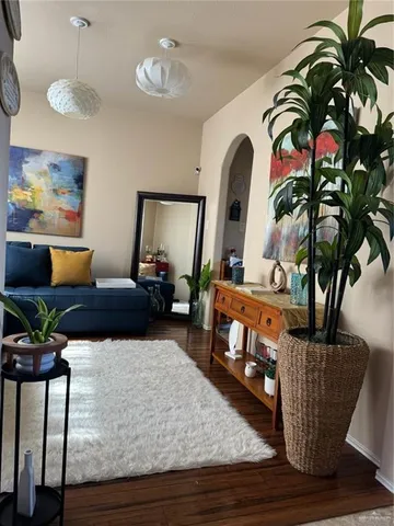 a living room with furniture and a potted plant