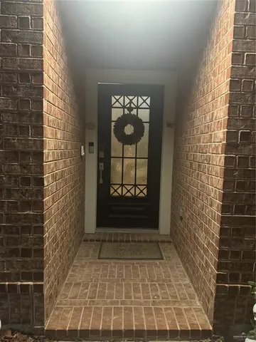 a view of a door of a house with windows