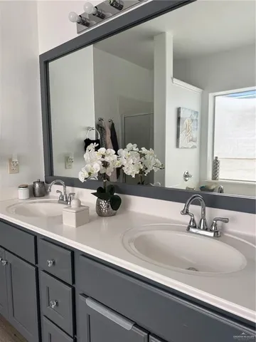 a bathroom with sink and mirror
