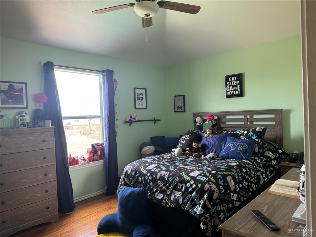 3407 San Angelo Street Mission, TX 78572 - Photo 28 of 40 a bed sitting in a bedroom next to a window