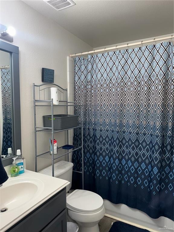 3407 San Angelo Street Mission, TX 78572 - Photo 30 of 40 a bathroom with a sink a toilet and shower
