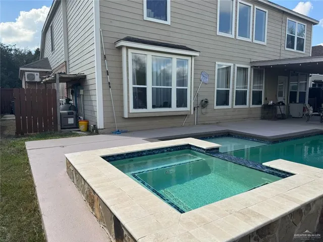 a view of a house with pool and a yard