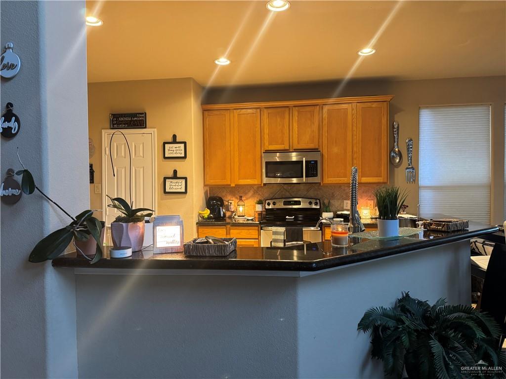 3407 San Angelo Street Mission, TX 78572 - Photo 6 of 40 a view of a kitchen with kitchen island a sink appliances and cabinets