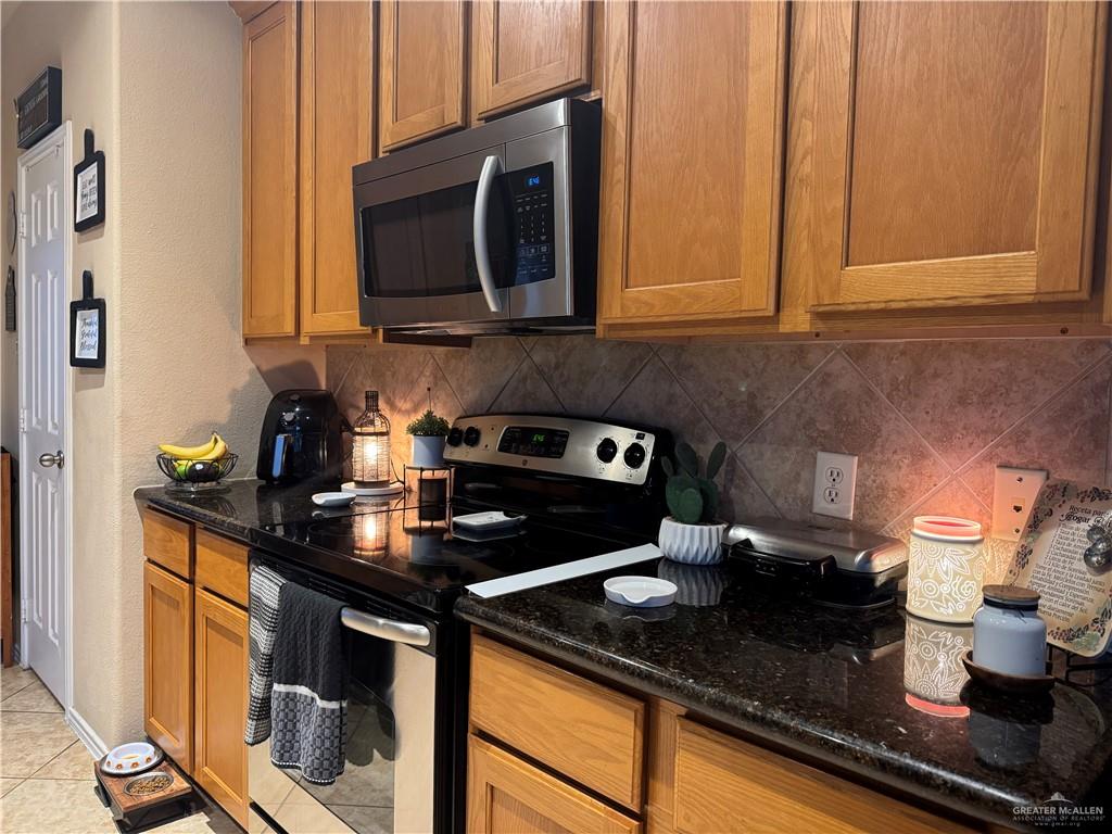 3407 San Angelo Street Mission, TX 78572 - Photo 8 of 40 a kitchen with stainless steel appliances granite countertop a sink stove and microwave