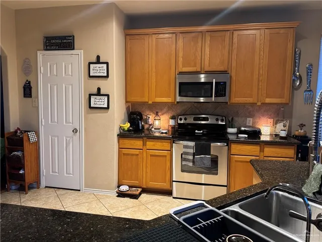 a kitchen with stainless steel appliances a stove a microwave and a refrigerator
