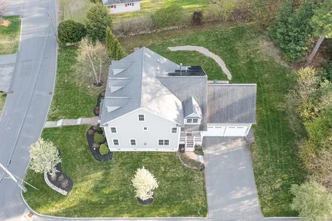 an aerial view of a house with outdoor space