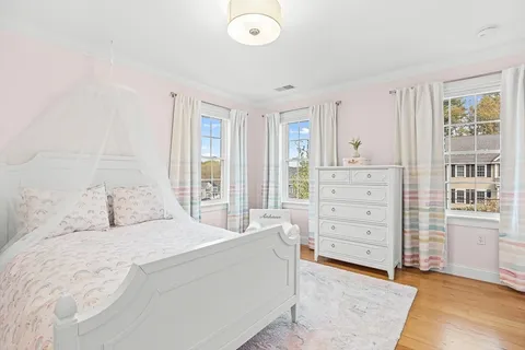 a spacious bedroom with a bed and cabinet