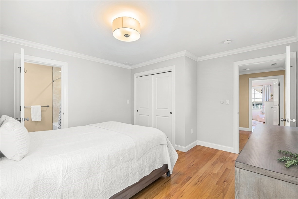 15 Maryvale Road Burlington, MA 01803 - Photo 30 of 42 a bedroom with a bed and a chandelier