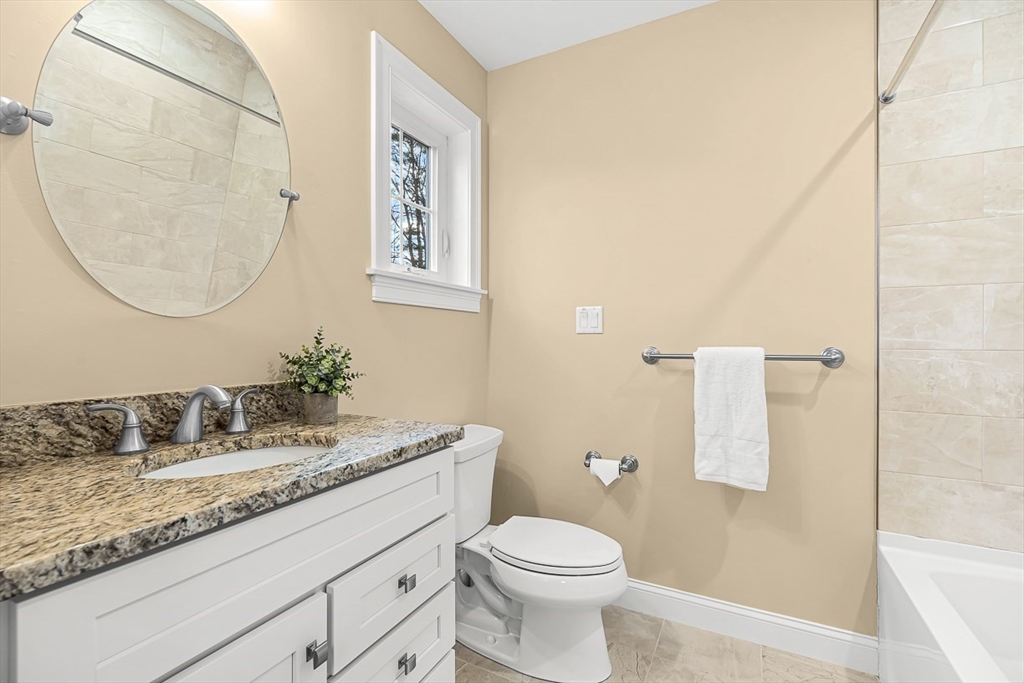 15 Maryvale Road Burlington, MA 01803 - Photo 31 of 42 a bathroom with a granite countertop sink a toilet and a mirror