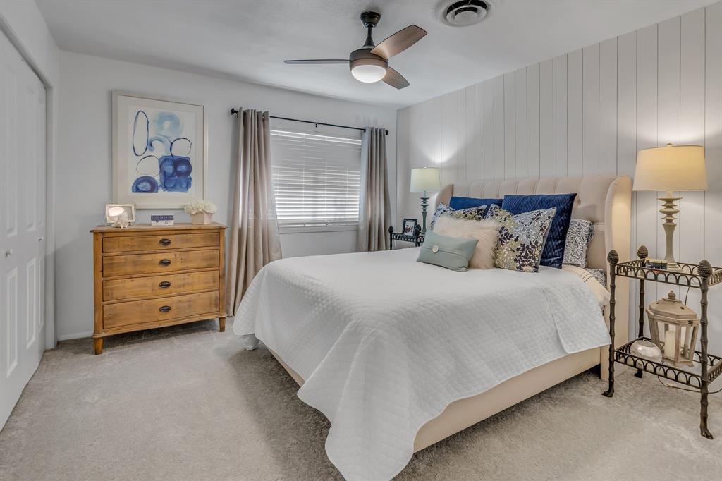 3449 West T Parr Road Grapevine, TX 76051 - Photo 21 of 32 a bedroom with a bed a dresser and painting on the wall