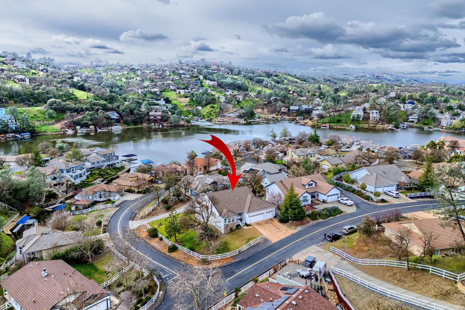 an aerial view of a house with a lake view