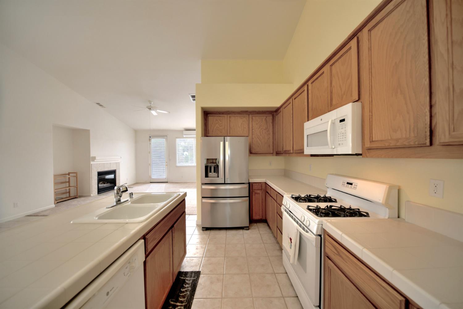 6250 Bluff View Road Copperopolis, CA 95228 - Photo 11 of 76 a kitchen with a sink stove and refrigerator