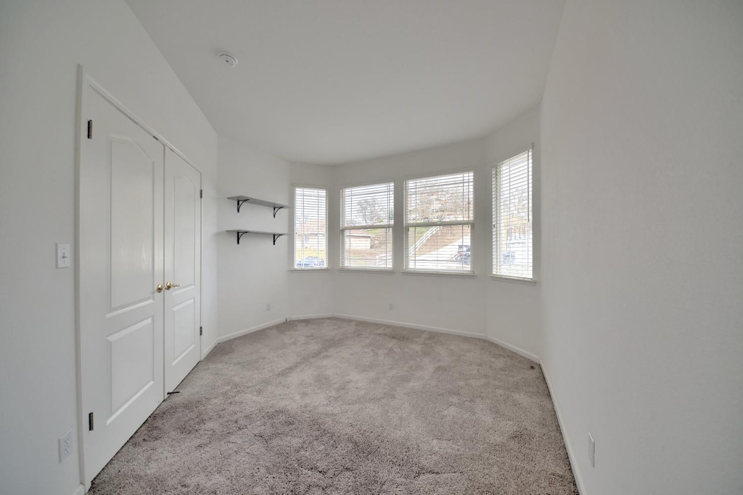 6250 Bluff View Road Copperopolis, CA 95228 - Photo 27 of 76 an empty room with windows