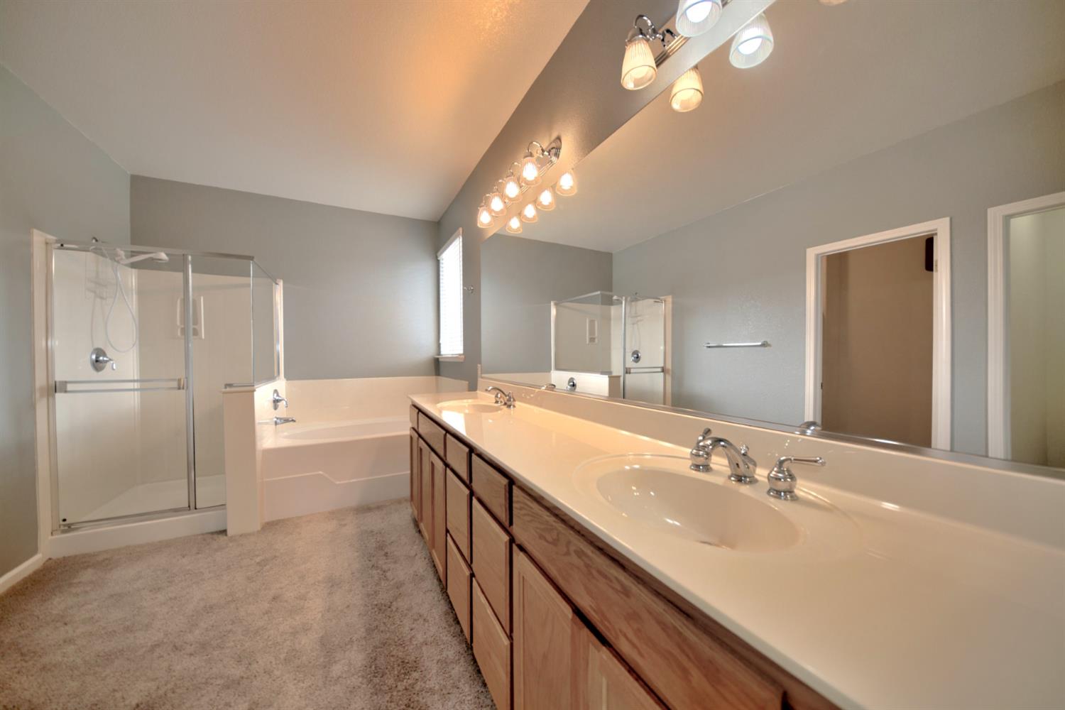 6250 Bluff View Road Copperopolis, CA 95228 - Photo 39 of 76 a bathroom with a double vanity sink mirror and shower