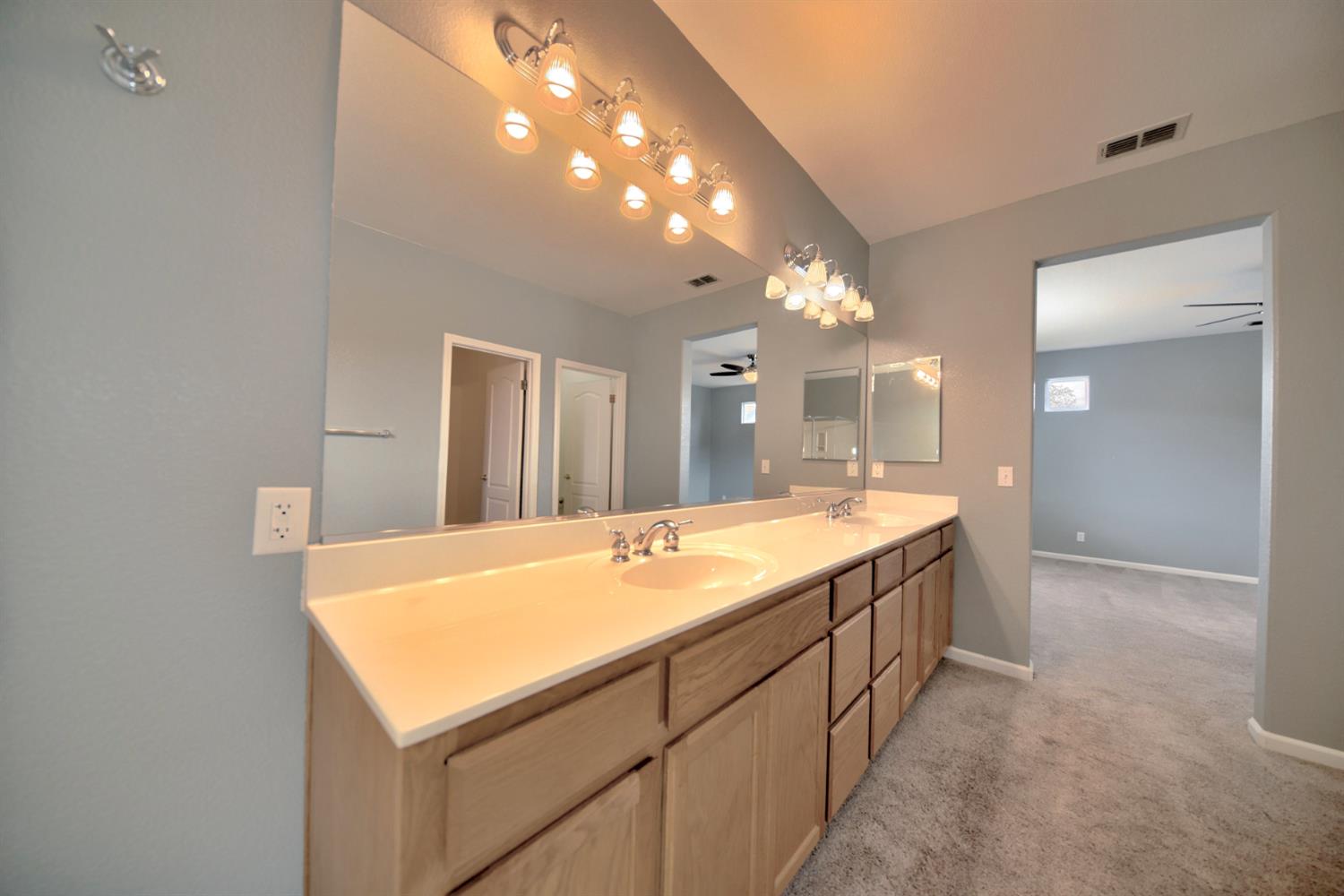 6250 Bluff View Road Copperopolis, CA 95228 - Photo 59 of 76 a spacious bathroom with a sink and a mirror