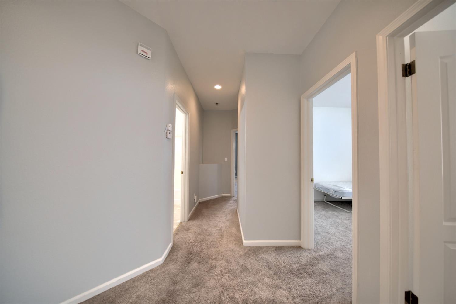 6250 Bluff View Road Copperopolis, CA 95228 - Photo 60 of 76 a view of hallway with a hallway and wooden shelves