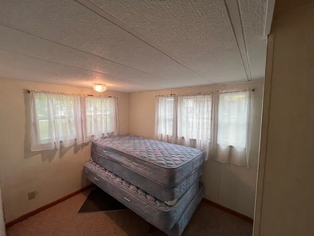 a view of kitchen with a refrigerator and a stove