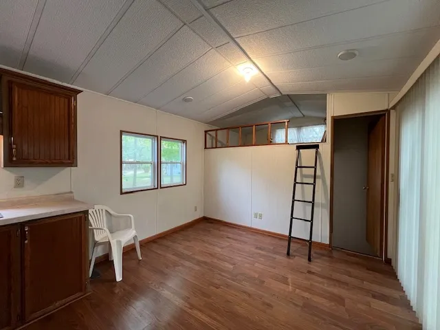 a workspace with wooden floor and a window