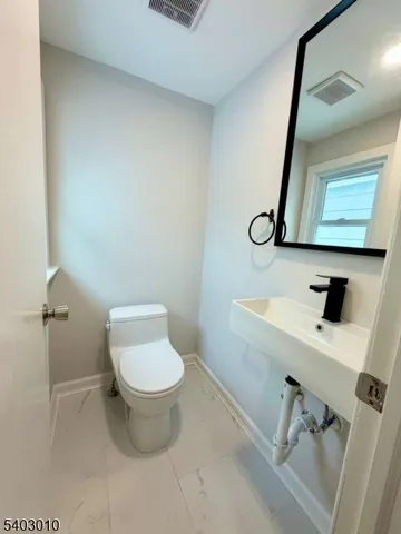 a bathroom with a toilet and a sink