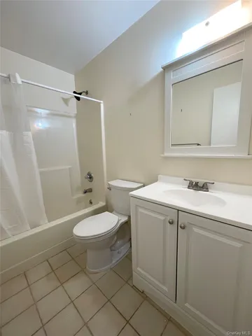 a bedroom with a bed and a lamp