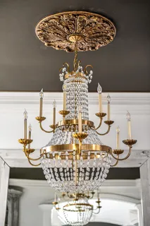 a living room with furniture fireplace and a chandelier
