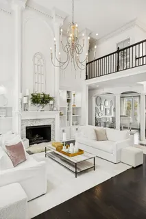 a large white kitchen with stainless steel appliances lots of counter top space