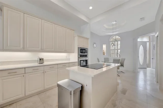 a living room with furniture a flat screen tv and a large window