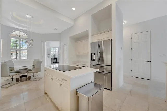 a living room with furniture a flat screen tv and a large window