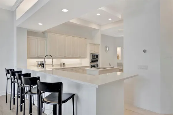 a view of a patio with table and chairs and potted plants