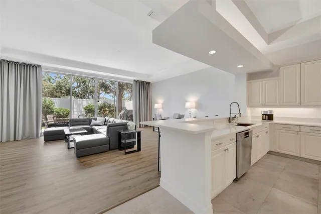 a view of a patio with table and chairs near a barbeque