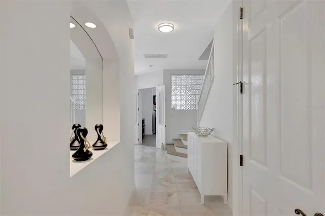 a bedroom with a bed and a flat tv screen on a dresser