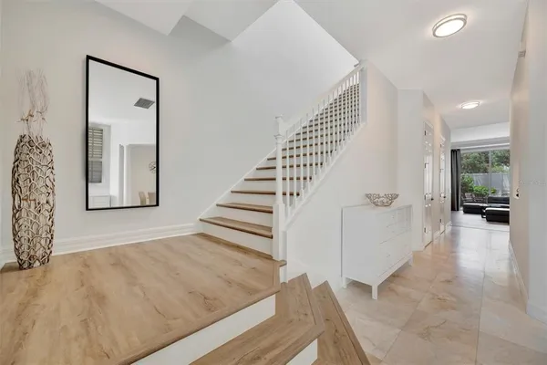 a spacious bedroom with a bed and wooden floor
